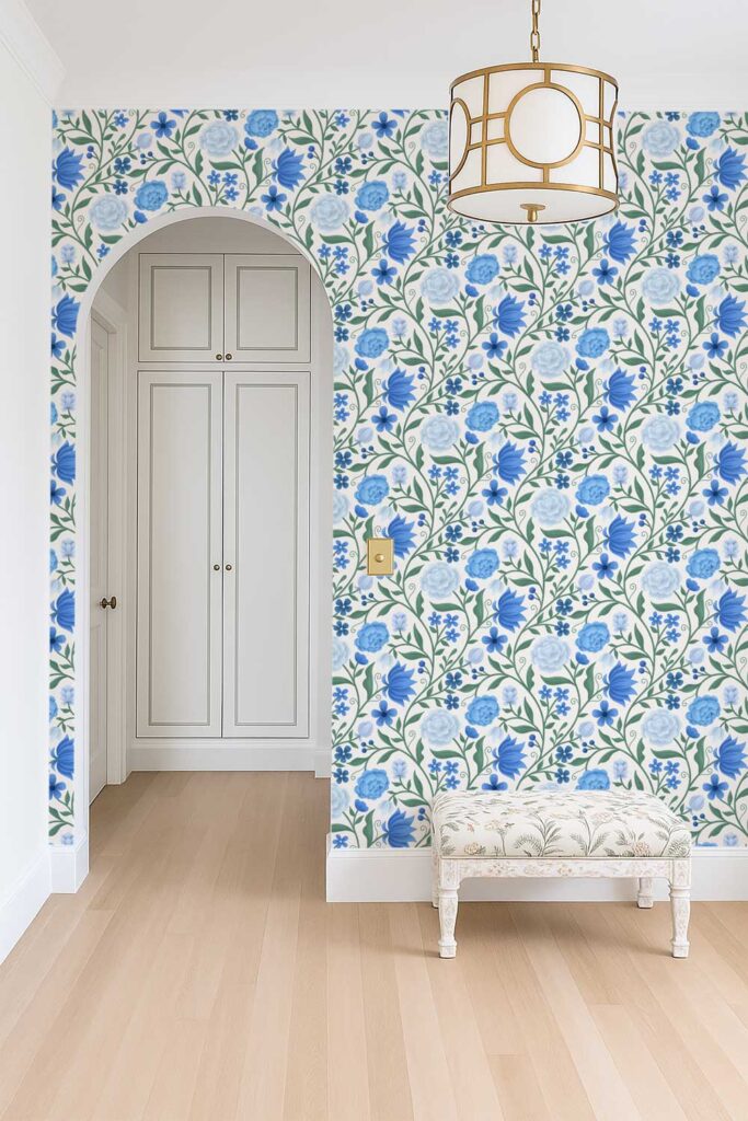 A mockup of an entry room with blue floral chintz-inspired wallpaper